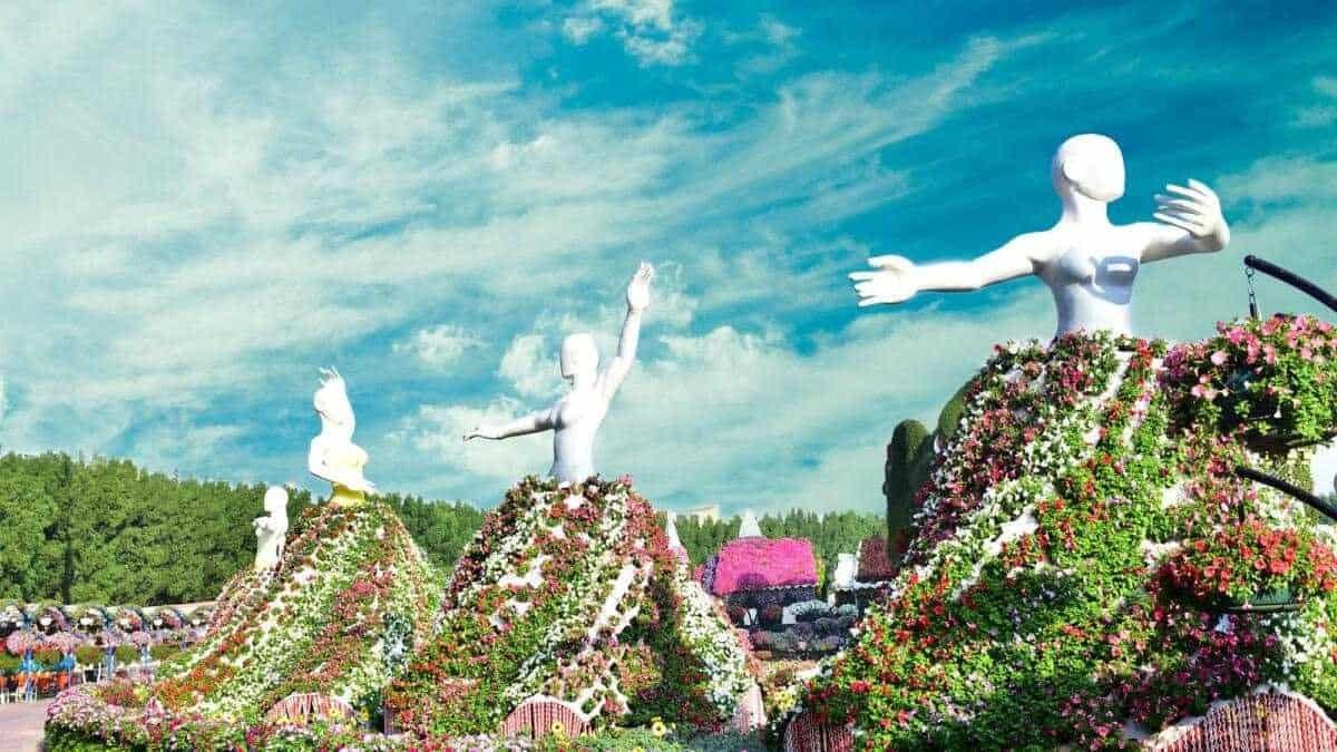 White floating lady sculptures with flower-covered gowns at Dubai Miracle Garden