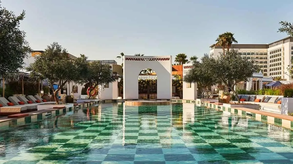 Aegean-style sunbeds and white umbrellas at Sirene Beach by GAIA on J1 Beach