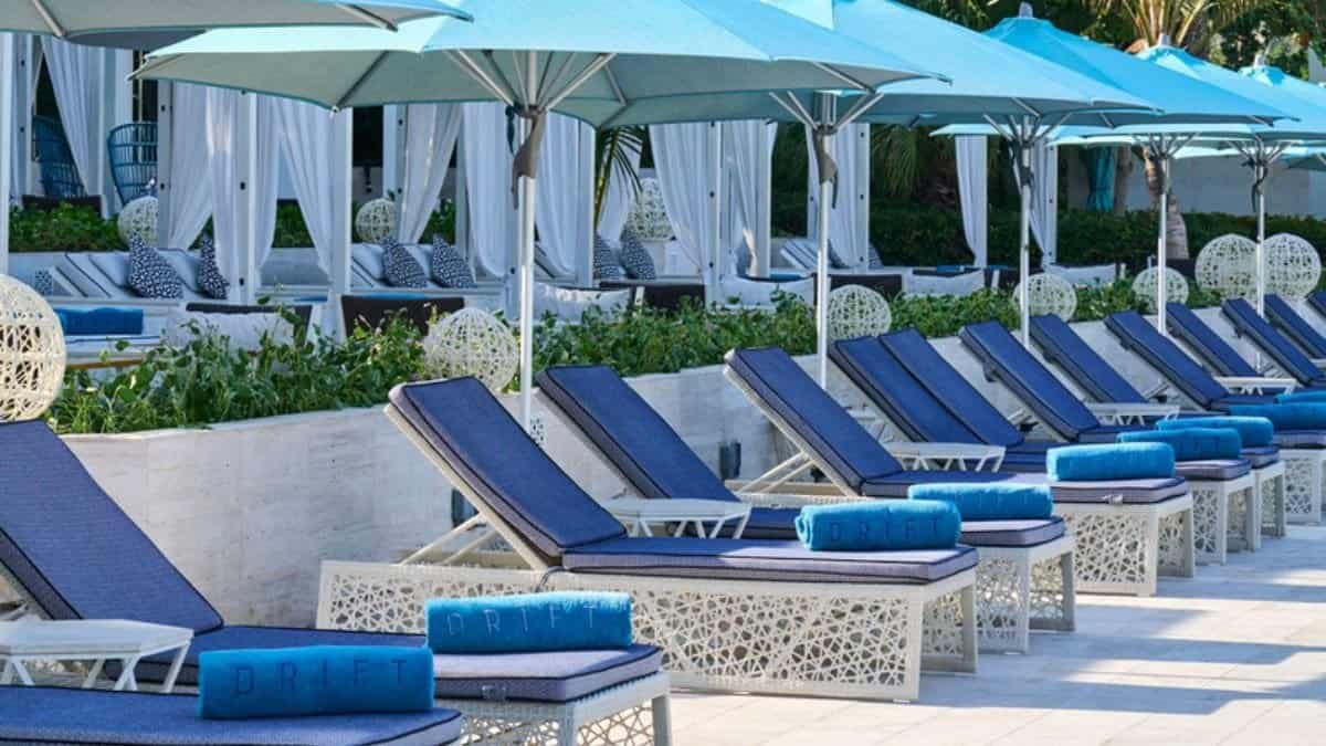 Quiet beach loungers under palms at Drift Beach, One&Only Royal Mirage