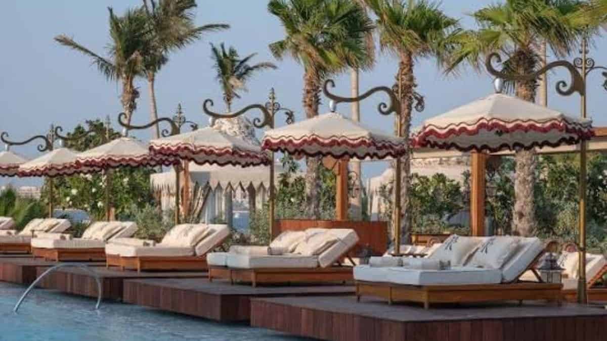 Maison Revka pool deck with scarlet-trimmed loungers at Delano Dubai