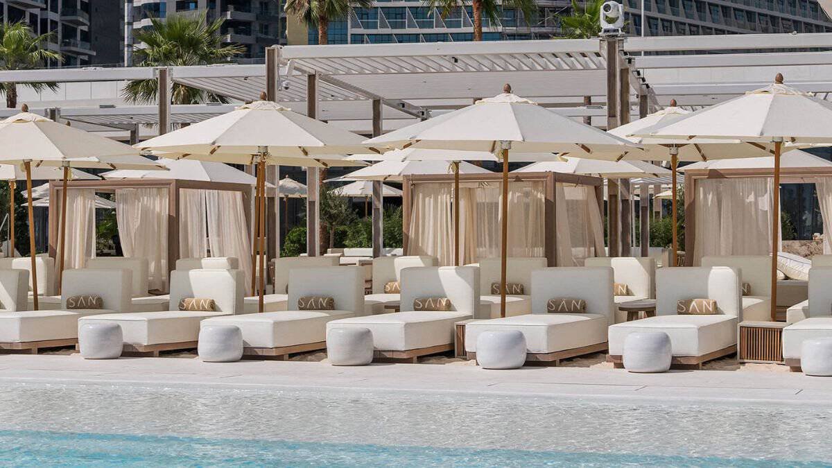 Loungers beside the temperature controlled pool at SAN Beach on Palm West Beach